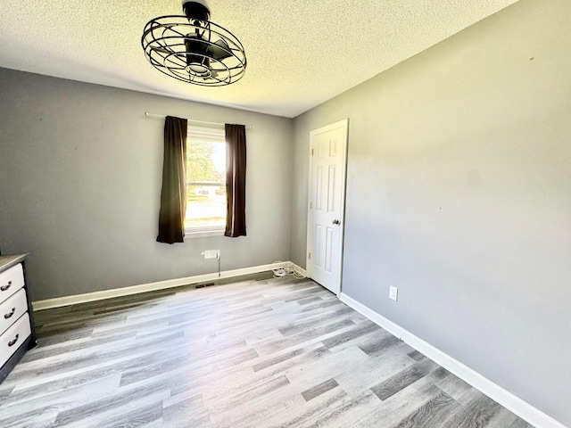 3409 Dutton Ct, Murfreesboro, TN 37130 - unfurnished bedroom featuring a textured ceiling and light wood-style flooring