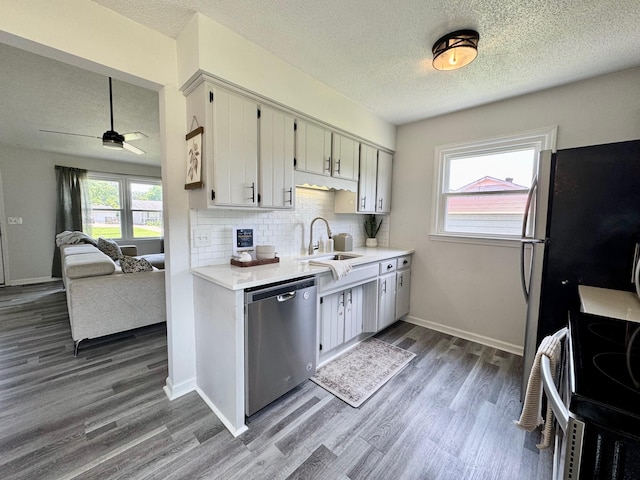 3409 Dutton Ct, Murfreesboro, TN 37130 - kitchen featuring dishwasher, a textured ceiling, electric stove, light countertops, and wood finished floors
