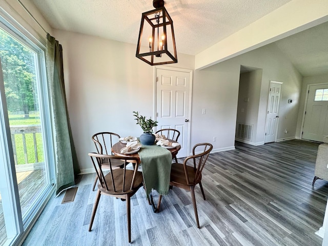 3409 Dutton Ct, Murfreesboro, TN 37130 - dining area featuring wood finished floors, a chandelier, and a textured ceiling