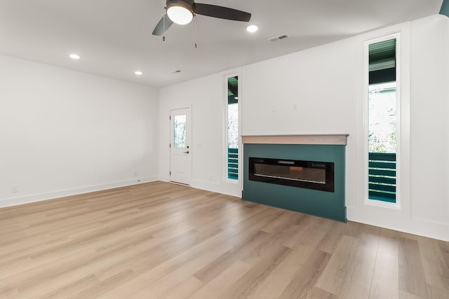 11 Dutch Dr, Clarksville, TN 37043 - unfurnished living room featuring a glass covered fireplace, light wood finished floors, recessed lighting, and ceiling fan