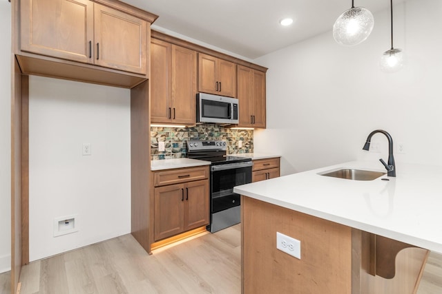 11 Dutch Dr, Clarksville, TN 37043 - kitchen with appliances with stainless steel finishes, light wood finished floors, decorative backsplash, brown cabinets, and light countertops