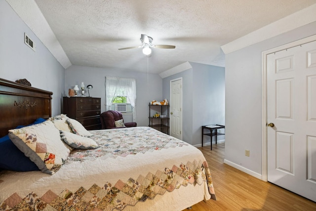 219 Lakeview Dr, Hohenwald, TN 38462 - bedroom featuring a textured ceiling, light wood-style flooring, lofted ceiling, a ceiling fan, and cooling unit