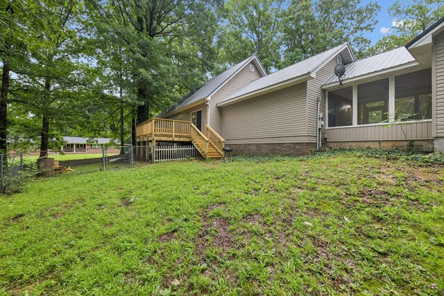 219 Lakeview Dr, Hohenwald, TN 38462 - view of side of home with a sunroom, a deck, and a metal roof
