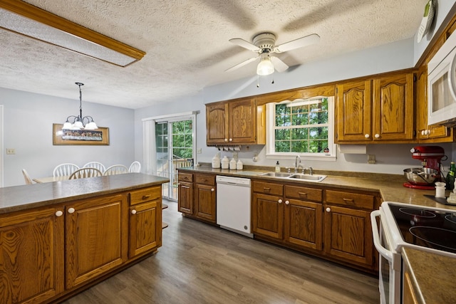 219 Lakeview Dr, Hohenwald, TN 38462 - kitchen featuring white appliances, ceiling fan, brown cabinetry, a textured ceiling, and dark countertops