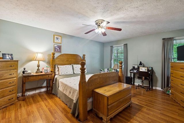 219 Lakeview Dr, Hohenwald, TN 38462 - bedroom featuring wood finished floors, multiple windows, a textured ceiling, and ceiling fan