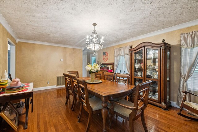219 Lakeview Dr, Hohenwald, TN 38462 - dining room featuring hardwood / wood-style flooring, a textured ceiling, a chandelier, and ornamental molding