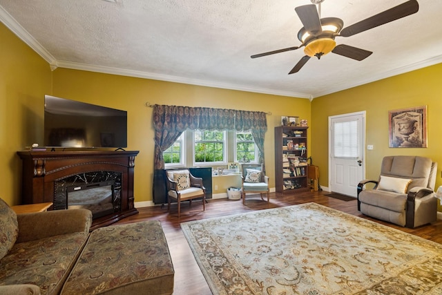 219 Lakeview Dr, Hohenwald, TN 38462 - living area with ornamental molding, wood finished floors, a ceiling fan, a premium fireplace, and a textured ceiling