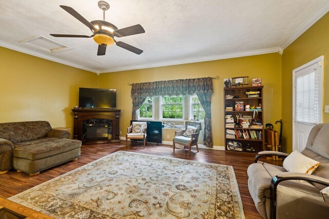 219 Lakeview Dr, Hohenwald, TN 38462 - living room with attic access, ornamental molding, wood finished floors, a textured ceiling, and a fireplace
