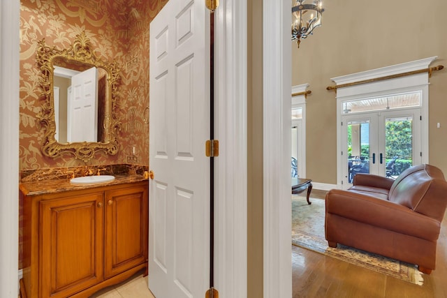 1512 Mirabella Way, Murfreesboro, TN 37130 - bathroom featuring wallpapered walls, vanity, wood finished floors, french doors, and a chandelier