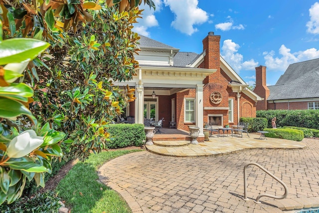 1512 Mirabella Way, Murfreesboro, TN 37130 - back of house featuring an outdoor brick fireplace, brick siding, a patio, a chimney, and a ceiling fan