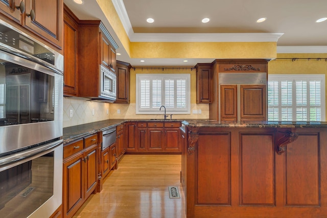 1512 Mirabella Way, Murfreesboro, TN 37130 - kitchen with built in appliances, ornamental molding, a warming drawer, dark stone countertops, and light wood finished floors