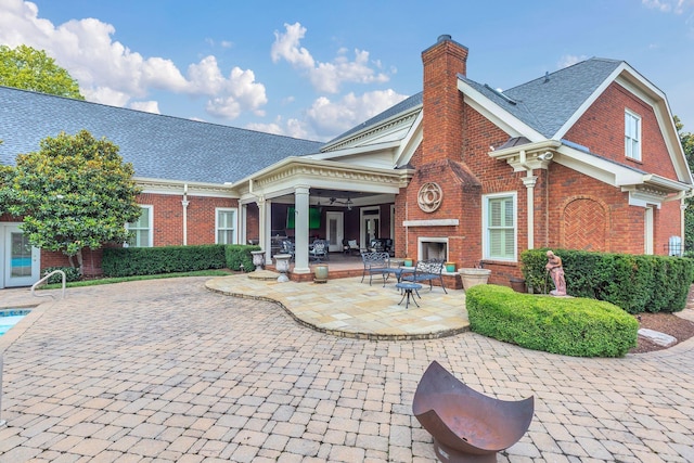 1512 Mirabella Way, Murfreesboro, TN 37130 - back of property with brick siding, a brick fireplace, a patio area, a chimney, and a ceiling fan