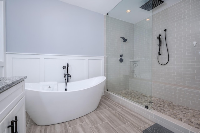 822 Manner Ln, Lebanon, TN 37087 - bathroom with tiled shower, a soaking tub, a decorative wall, wainscoting, and vanity