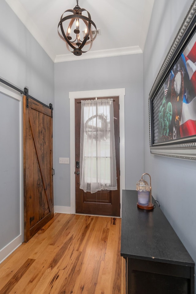 822 Manner Ln, Lebanon, TN 37087 - entrance foyer with wood finished floors, a chandelier, crown molding, and a barn door