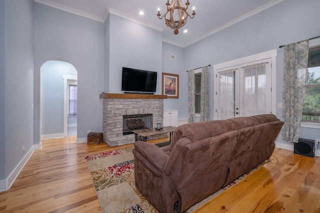 822 Manner Ln, Lebanon, TN 37087 - living area featuring a high ceiling, arched walkways, a stone fireplace, a chandelier, and light wood-style floors