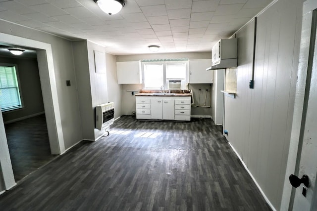 289 Long St W, Mc Ewen, TN 37101 - kitchen featuring heating unit, dark wood-style flooring, and white cabinets