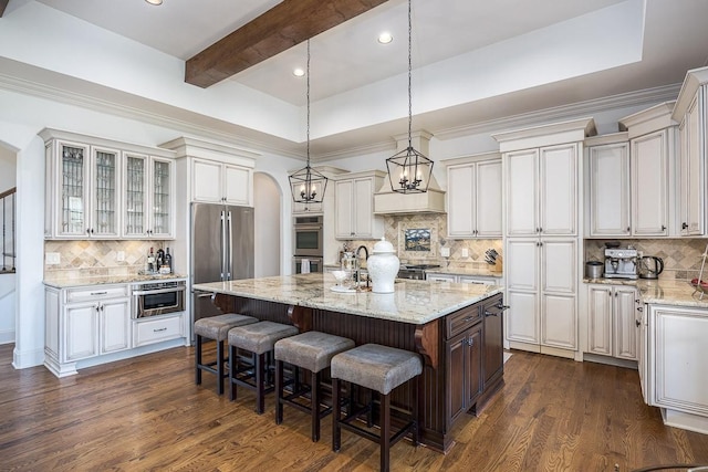 7216 Wildings Blvd, College Grove, TN 37046 - kitchen with backsplash, an island with sink, stainless steel appliances, arched walkways, and recessed lighting