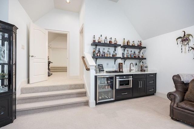 7216 Wildings Blvd, College Grove, TN 37046 - indoor wet bar featuring light carpet, vaulted ceiling, wine cooler, stainless steel oven, and stairs