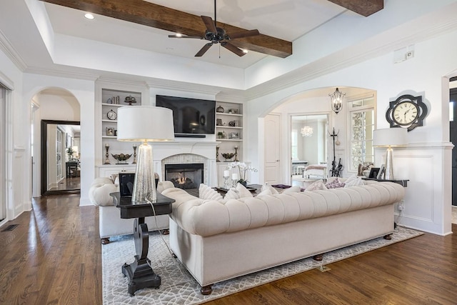 7216 Wildings Blvd, College Grove, TN 37046 - living area with arched walkways, ceiling fan, a brick fireplace, dark wood finished floors, and built in features