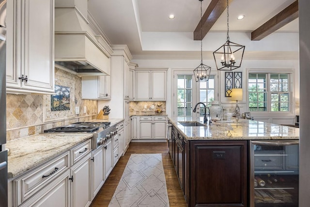 7216 Wildings Blvd, College Grove, TN 37046 - kitchen with wine cooler, custom exhaust hood, plenty of natural light, a chandelier, and beamed ceiling