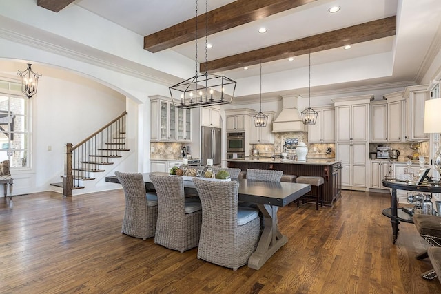 7216 Wildings Blvd, College Grove, TN 37046 - dining area with a chandelier, stairs, dark wood-style floors, beam ceiling, and arched walkways