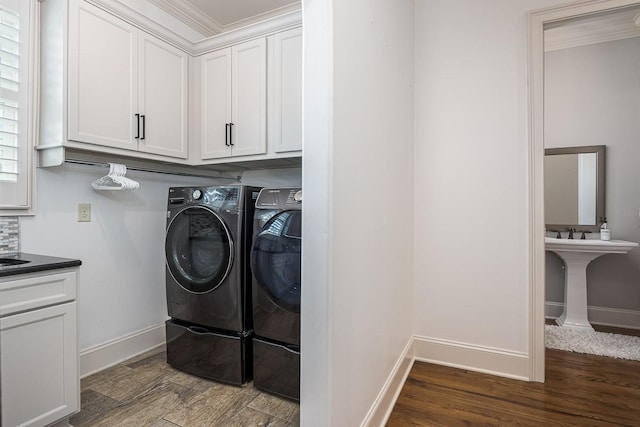 7216 Wildings Blvd, College Grove, TN 37046 - laundry room featuring washing machine and dryer, crown molding, wood finished floors, and cabinet space