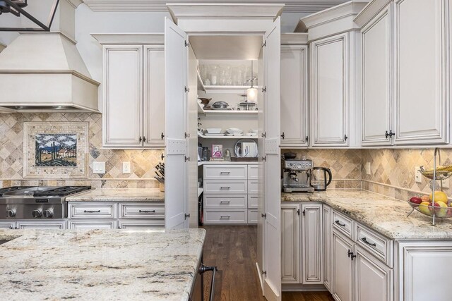 7216 Wildings Blvd, College Grove, TN 37046 - kitchen featuring custom exhaust hood, stainless steel gas stovetop, backsplash, dark wood finished floors, and crown molding