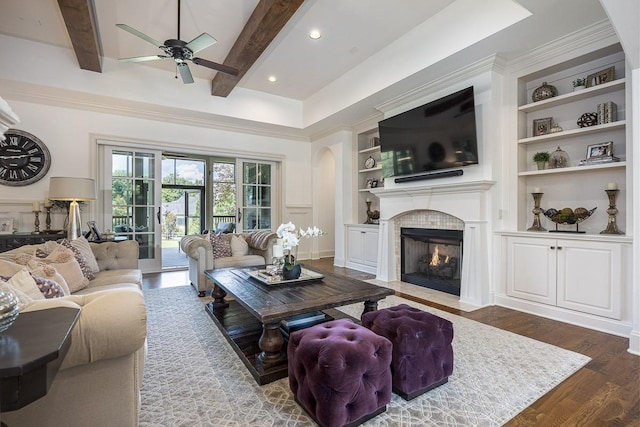 7216 Wildings Blvd, College Grove, TN 37046 - living area featuring a ceiling fan, built in features, wood finished floors, a fireplace with flush hearth, and beam ceiling
