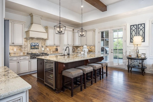 7216 Wildings Blvd, College Grove, TN 37046 - kitchen with custom exhaust hood, beverage cooler, dark wood finished floors, a breakfast bar, and an island with sink
