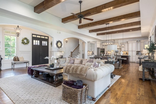 7216 Wildings Blvd, College Grove, TN 37046 - living area featuring arched walkways, a chandelier, stairs, beamed ceiling, and ceiling fan