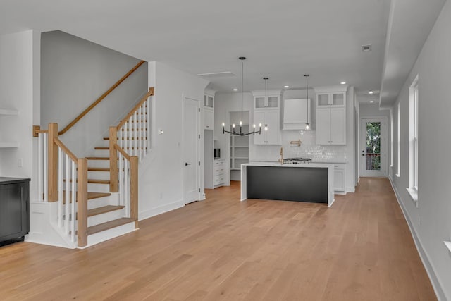 1117 38th Ave N Unit B, Nashville, TN 37209 - kitchen with light wood finished floors, recessed lighting, white cabinetry, and glass insert cabinets