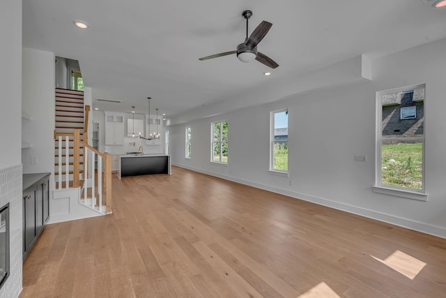 1117 38th Ave N Unit B, Nashville, TN 37209 - unfurnished living room with light wood-style floors, stairway, a ceiling fan, and recessed lighting