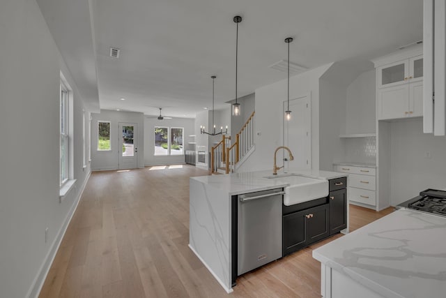 1117 38th Ave N Unit B, Nashville, TN 37209 - kitchen featuring stainless steel dishwasher, white cabinets, open floor plan, and light wood-style flooring