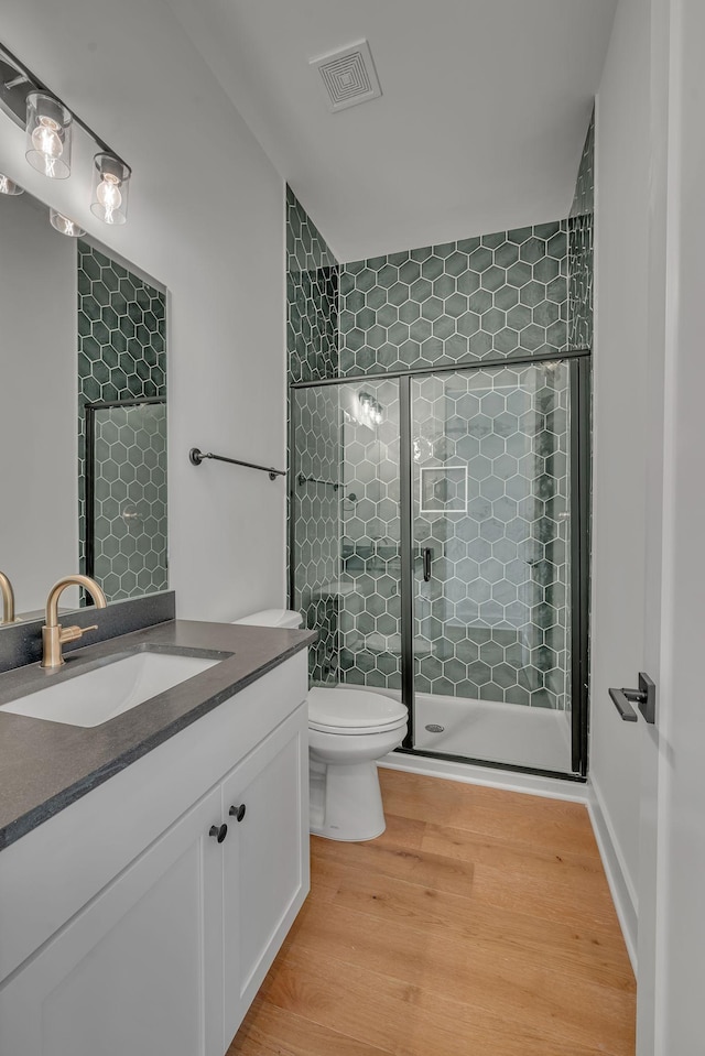 1117 38th Ave N Unit B, Nashville, TN 37209 - bathroom featuring vanity, wood finished floors, and a tile shower