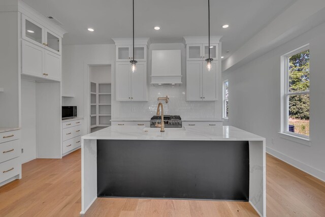 1117 38th Ave N Unit B, Nashville, TN 37209 - kitchen with stainless steel appliances, backsplash, light wood-type flooring, light stone countertops, and recessed lighting