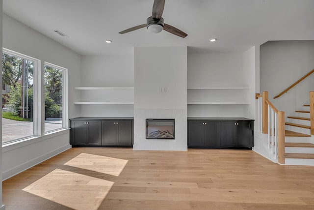1117 38th Ave N Unit B, Nashville, TN 37209 - unfurnished living room featuring ceiling fan, stairs, light wood-style floors, built in shelves, and recessed lighting