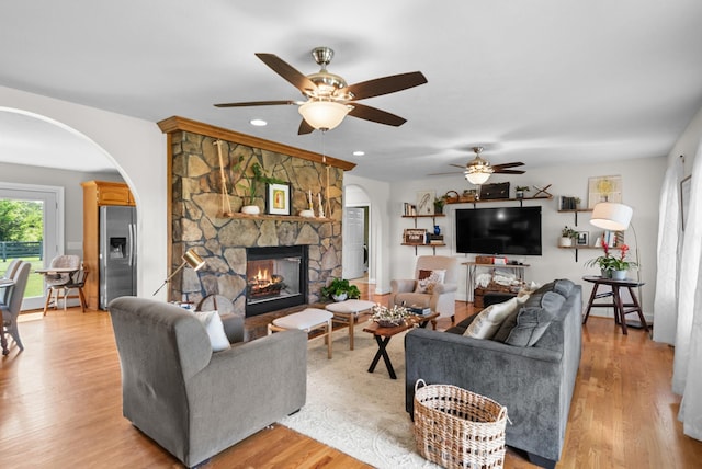 3406 Parks Ln, Spring Hill, TN 37174 - living room featuring arched walkways, a fireplace, light wood-style floors, and recessed lighting