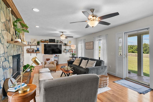3406 Parks Ln, Spring Hill, TN 37174 - living area featuring light wood-style flooring, a ceiling fan, recessed lighting, and a stone fireplace