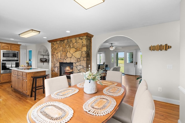 3406 Parks Ln, Spring Hill, TN 37174 - dining space featuring arched walkways, light wood-style floors, a fireplace, recessed lighting, and a ceiling fan
