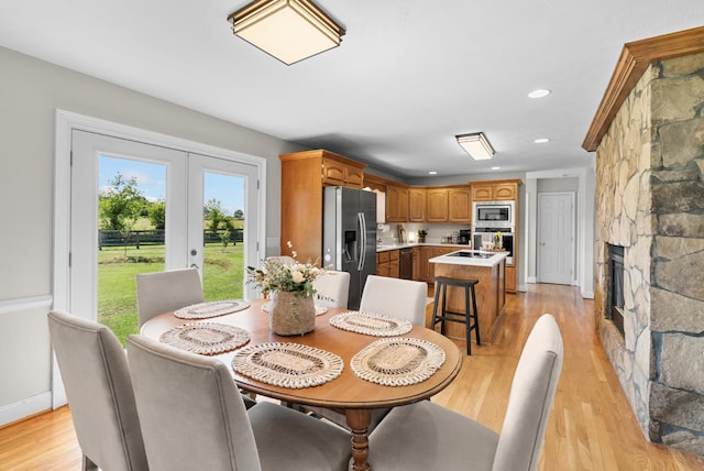 3406 Parks Ln, Spring Hill, TN 37174 - dining area featuring a stone fireplace, light wood finished floors, french doors, and recessed lighting