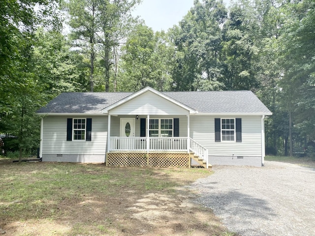 205 Windy Park Dr, Mc Ewen, TN 37101 - view of front of house with crawl space, a porch, roof with shingles, and view of wooded area