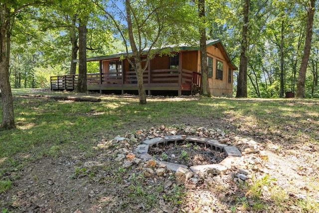 15578 Birdsong Rd, Holladay, TN 38341 - back of house featuring a wooden deck and an outdoor fire pit