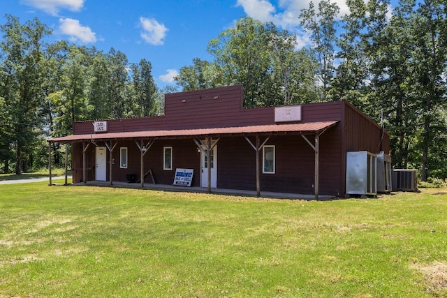 15578 Birdsong Rd, Holladay, TN 38341 - view of front facade with covered porch, a front lawn, and a metal roof