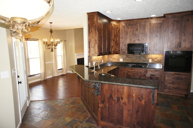 1102 Fairways, Lebanon, TN 37087 - kitchen featuring black appliances, a chandelier, a peninsula, backsplash, and stone tile floors