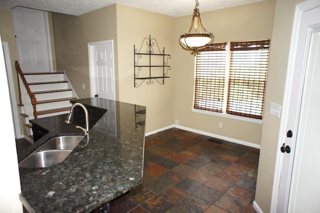 1102 Fairways, Lebanon, TN 37087 - kitchen featuring stone tile floors, hanging light fixtures, and dark stone counters