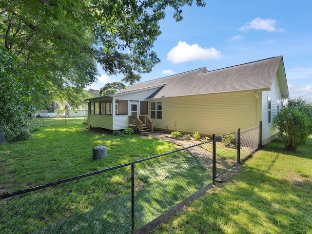 43 Shady Cove Ct, Estill Springs, TN 37330 - rear view of house with a sunroom, a fenced backyard, and a shingled roof