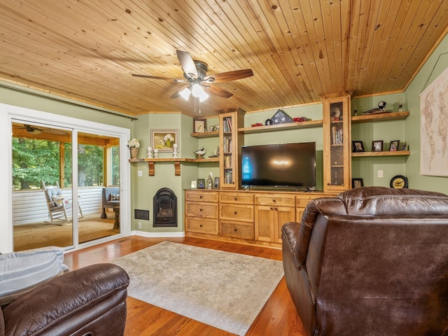 43 Shady Cove Ct, Estill Springs, TN 37330 - living room with wood finished floors, a ceiling fan, a glass covered fireplace, and wooden ceiling