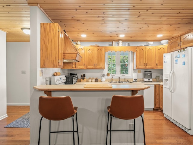 43 Shady Cove Ct, Estill Springs, TN 37330 - kitchen featuring white appliances, wooden ceiling, a peninsula, light wood-type flooring, and a breakfast bar