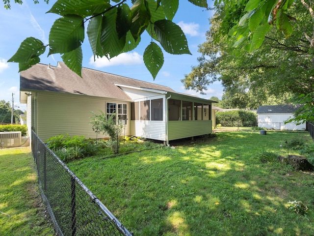 43 Shady Cove Ct, Estill Springs, TN 37330 - rear view of house featuring a sunroom, a fenced backyard, and a shingled roof