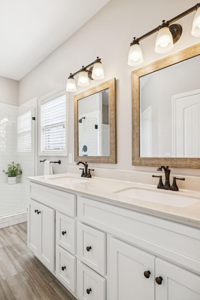 1361 Neil Rd, Chapel Hill, TN 37034 - bathroom featuring a tile shower, double vanity, and wood finished floors